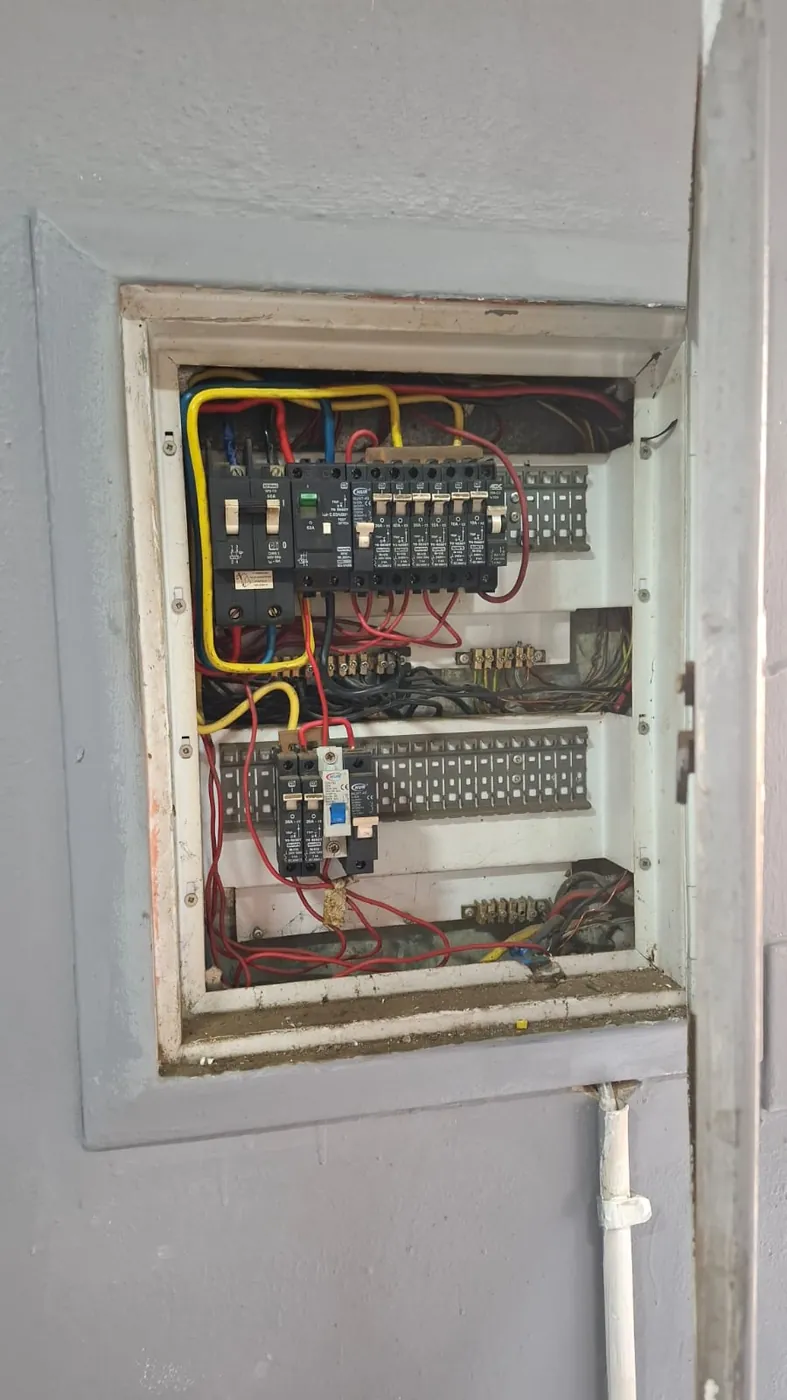 An open distribution board with its breakers and wiring