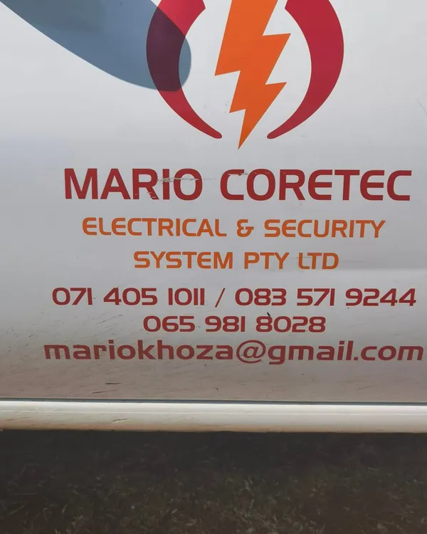 The side of his van, signwritten with the company name, three phone numbers and email